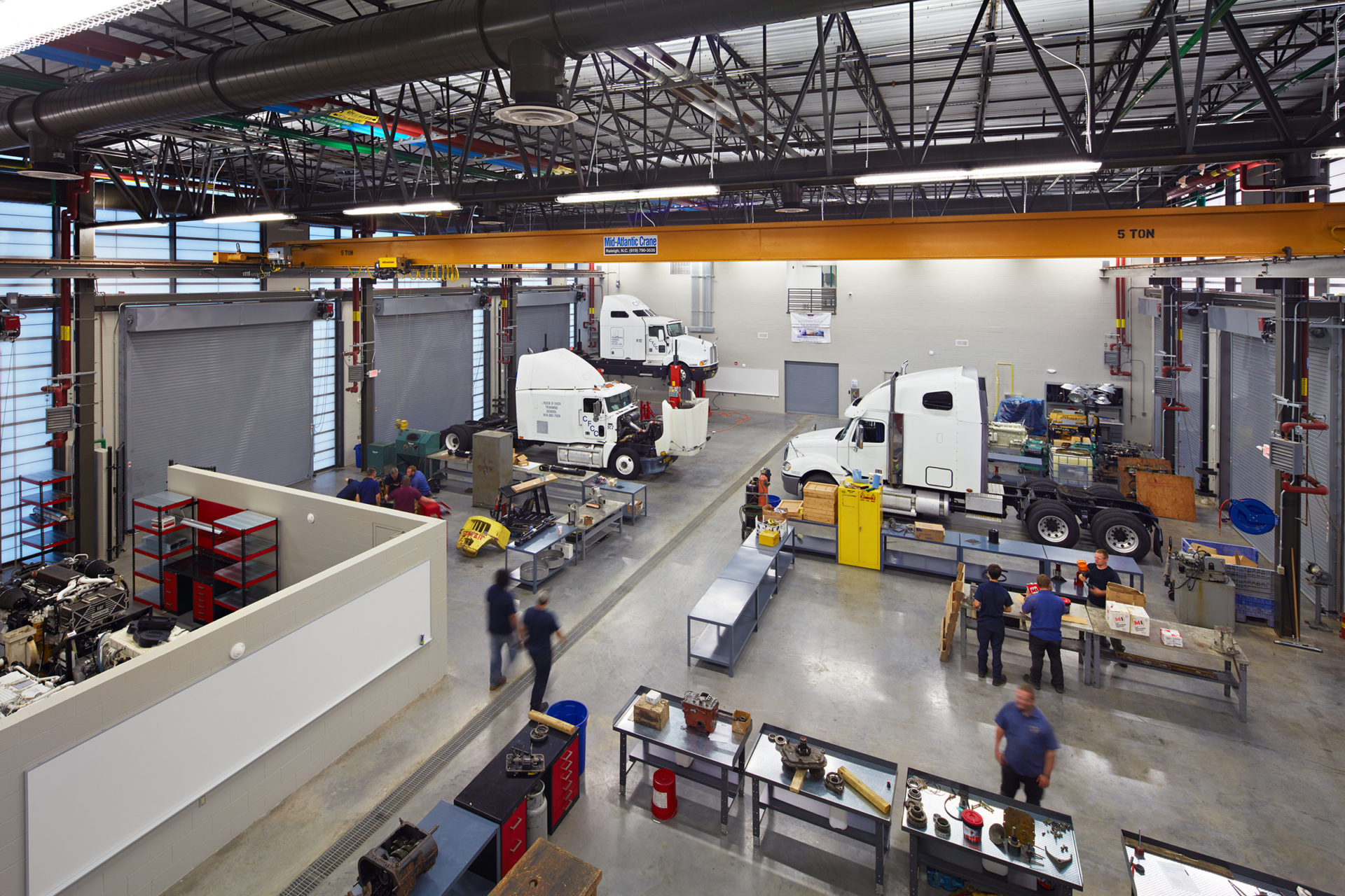Aerial view of truck bay in the Heavy Equipment and Transport Technology Building (HEATT) at Cape Fear Community College in Castle Hayne, NC; Architect: Clark Nexsen
